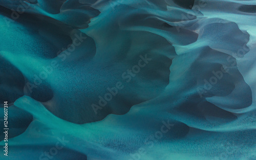 Aerial view of beautiful turquoise water with abstract patterns and smooth waves, Selfoss, Iceland.