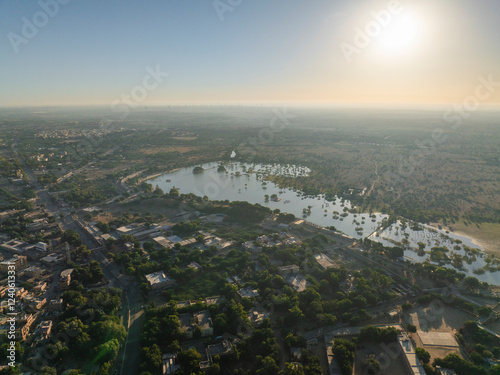 Aerial view of Gadisar Lake with serene reflections and lush greenery, Jaisalmer, India. photo