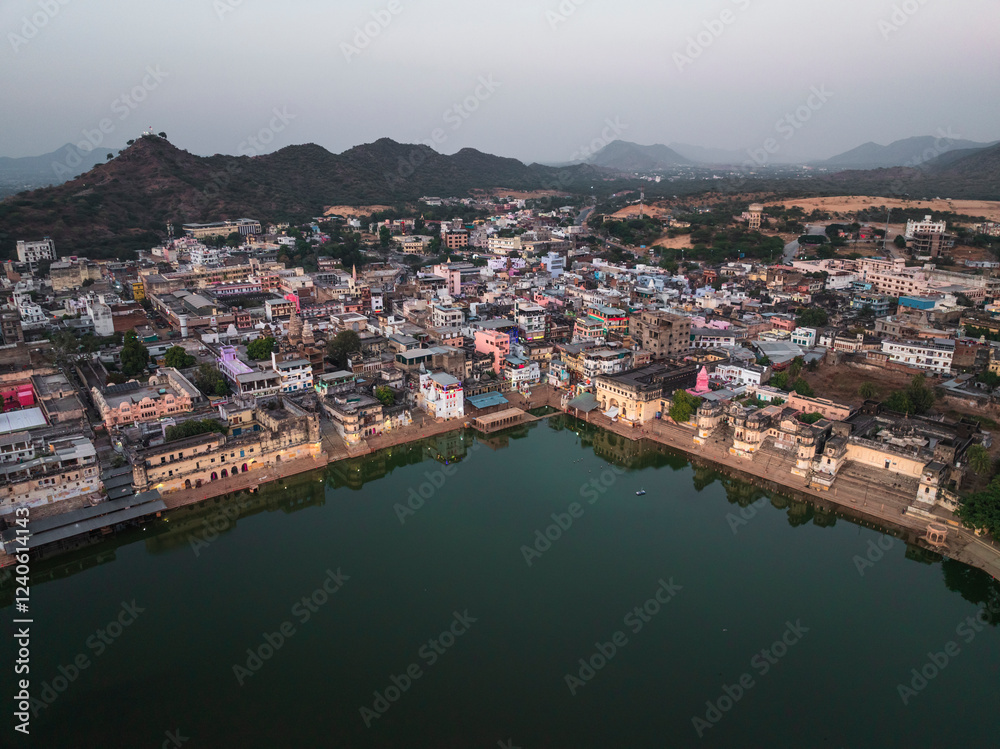 Aerial view of Pushkar Lake with colorful buildings and serene ghats, Pushkar, India. Aerial view of Pushkar Lake with colorful buildings and serene ghats, Pushkar, India.