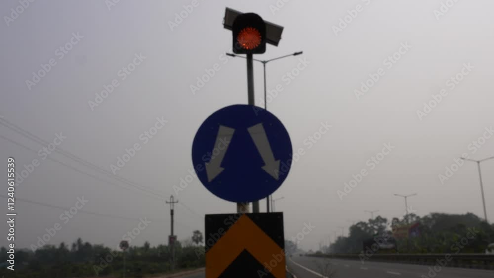 Traffic sign indicating the left right movement with caution sign and solar operated traffic signal on the highway