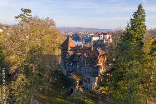 Aerial view of a picturesque historic castle surrounded by tranquil woodland and autumn foliage, Ozalj, Croatia. photo