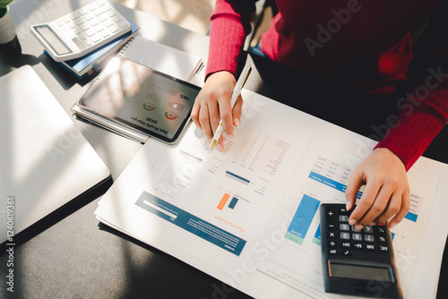 Portrait of a woman working on a tablet computer in a modern office. Make an account analysis report. real estate investment information financial and tax system concepts