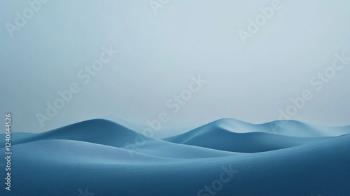 Rolling blue dunes stretch beneath a pale sky, forming a serene and minimalist landscape photo