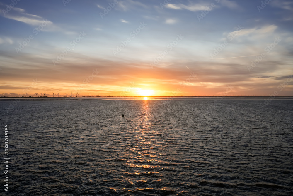 Landscape near Dagebüll. Nature with sunrise on the North Sea coast. Rising sun on the sea.
Landscape near Dagebüll. Nature with sunrise on the North Sea coast. Rising sun on the sea.