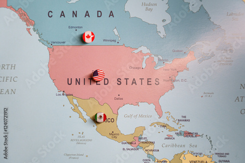  US flag push pin marking the United States on a map, with Mexico and Canada location pins visible. Tariffs. Trade wars. Import taxes photo