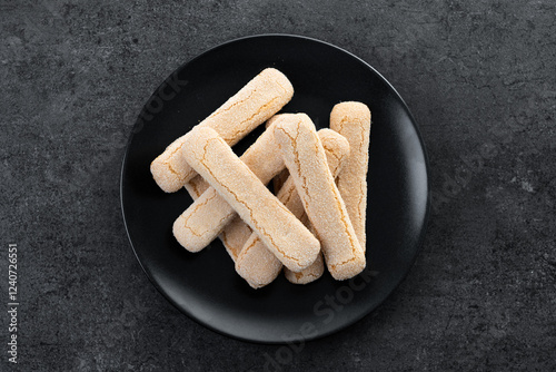 Italian biscuits ladyfingers savoiardi on black background