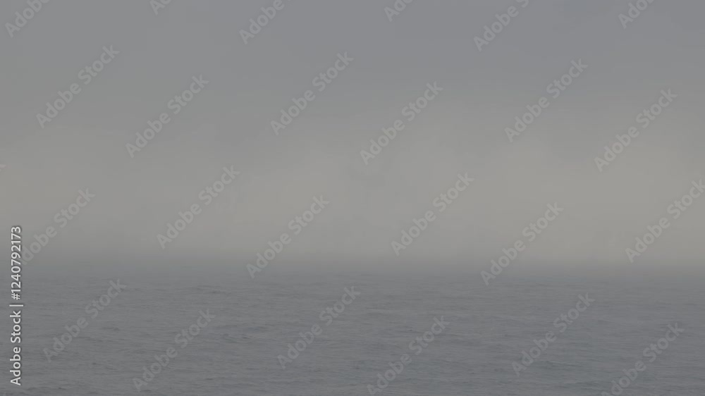 Fog rolling over a calm ocean on a cloudy day Fog rolling over a calm ocean on a cloudy day