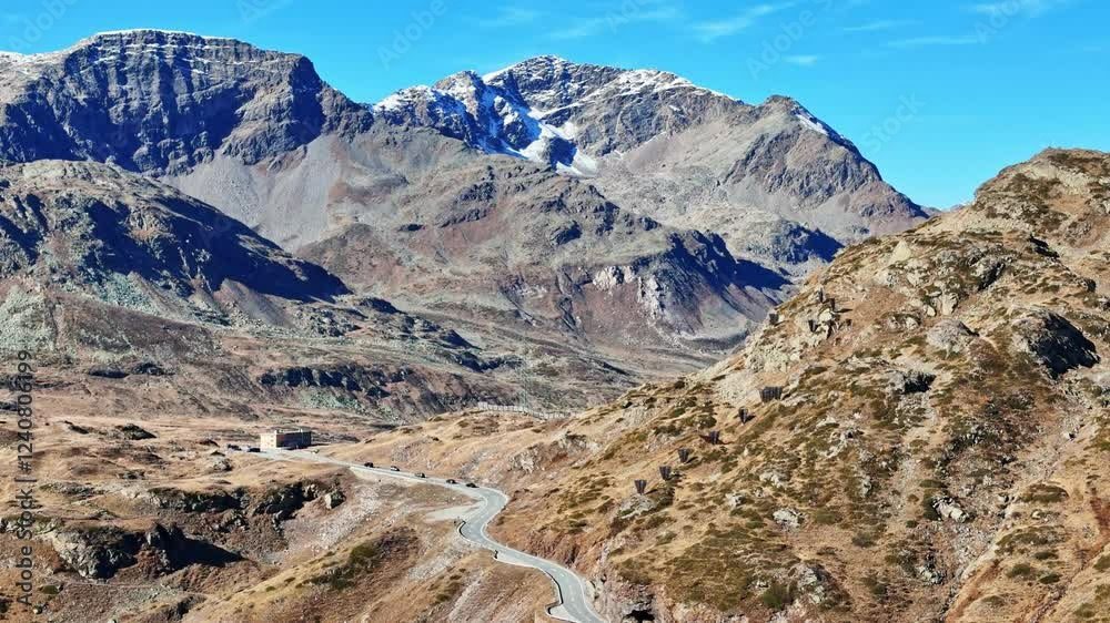 Aerial view of alpine landscape with Piz Cambrena and winding road through the valley, Samedan, Switzerland. Aerial view of alpine landscape with Piz Cambrena and winding road through the valley, Samedan, Switzerland.