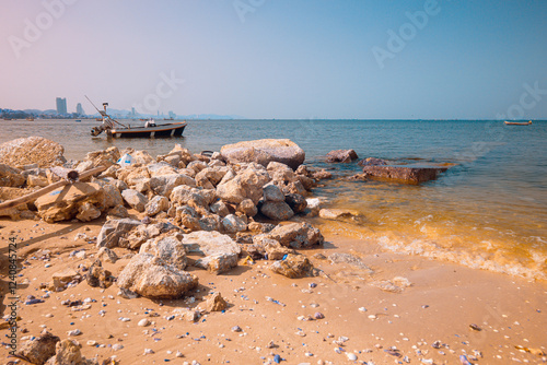 Infrared photography, a beach scene with a small boat anchored nearby photo