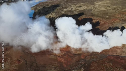 Aerial view of gunnuhver hot springs with steam and geothermal features in rugged volcanic landscape, reykjanes peninsula, iceland.