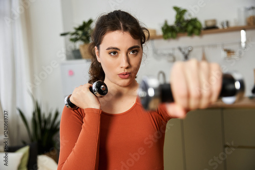 Cuadro en lienzo Young woman working out at home with determination and focus in a cozy environme