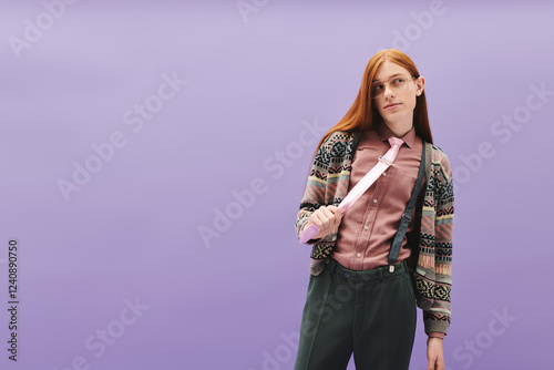 Young queer man displaying stylish fashion against a modern pastel backdrop