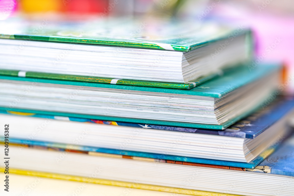 A close-up of a stack of children's books, with colorful covers, placed on a white surface. The image represents learning, fun, and childhood exploration. A close-up of a stack of children's books, with colorful covers, placed on a white surface. The image represents learning, fun, and childhood exploration.