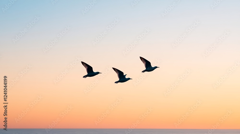 Fototapeta premium Elegant Blurred silhouette of flying birds against a soft lavender and peach gradient sky symbolizing early March migration and change