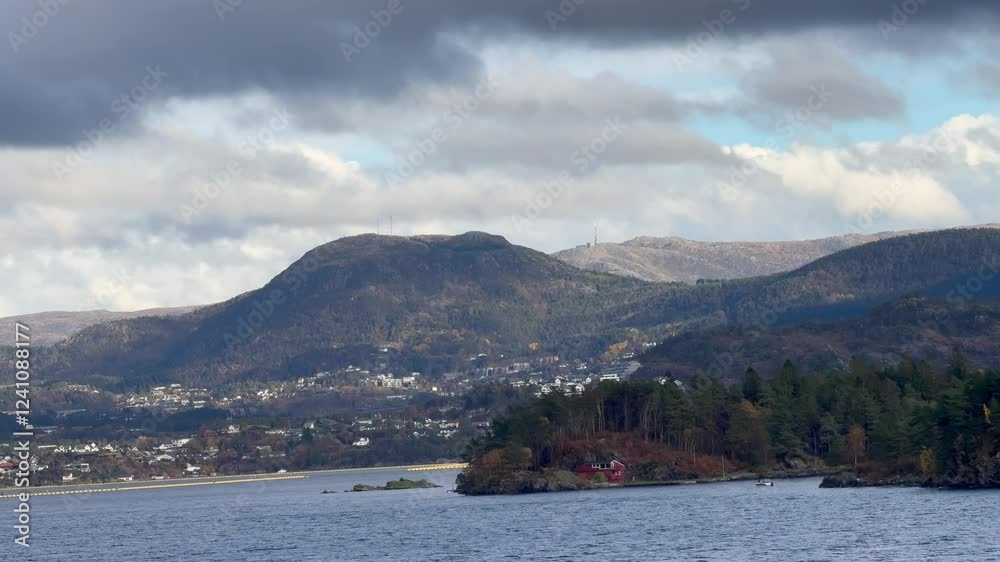Cruise in Norway. View of the fjord from the boat , view of the mountains from the boat, waterfalls, cruise ships and tender boats carrying tourists from ship to shore on a beautiful day with blue sky Cruise in Norway. View of the fjord from the boat , view of the mountains from the boat, waterfalls, cruise ships and tender boats carrying tourists from ship to shore on a beautiful day with blue sky
