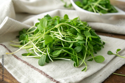 A small pile of fresh fenugreek leaves on a wooden table