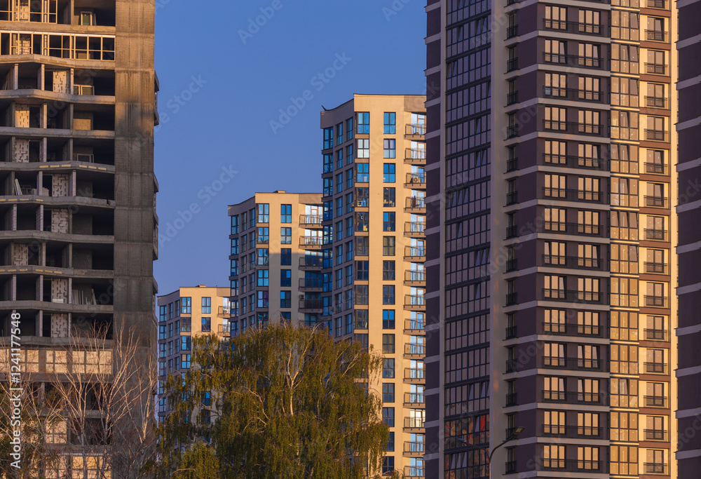 Fototapeta premium City view on a sunny day. Modern buildings, walls and windows. 
