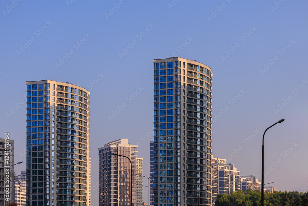 Modern buildings, walls and windows, reflections and sun rays. City view on a sunny day. Modern buildings, walls and windows, reflections and sun rays. City view on a sunny day.