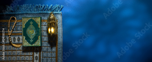 Quran. Book with Arabic title All Quran. Ramadan. Lantern for Muslim holy month Ramazan Kareem. Decorative Holiday lamp, Prayer Mat Islamic rug for Namaz. Symbol of fasting sawm, prayer salah.