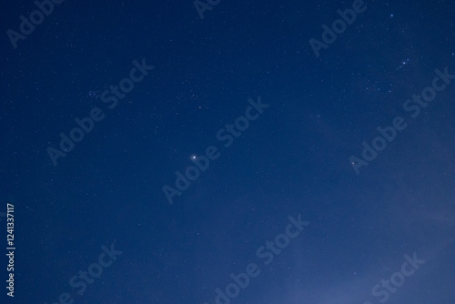 Fototapeta Naklejka Na Ścianę i Meble -  Starry night sky with prominent bright star and cloudy haze