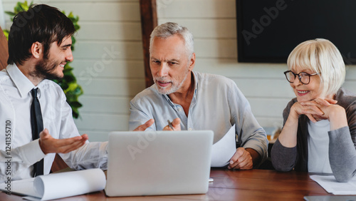Close up of senior couple sit at lawyer broker designer office look at laptop listen to offer proposal of qualified specialist. Older spouses customers of male realtor choose flat house on pc screen