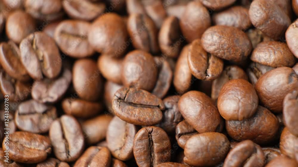 Rotating a pile of caffeine-free decaf coffee beans close-up Rotating a pile of caffeine-free decaf coffee beans close-up