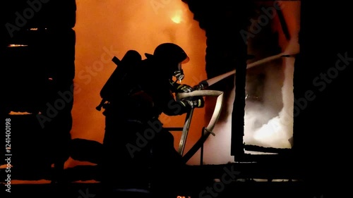 Firefighters extinguish the fire in the house. A strong fire inside the dwelling. A terrible tragedy for people. The night flame inside the home.