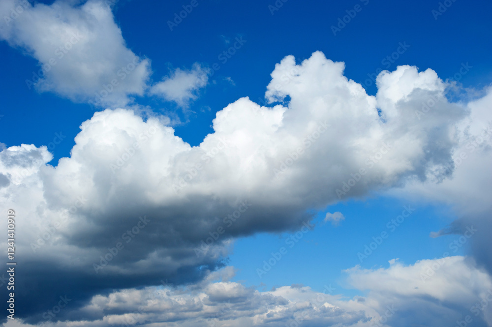 Fototapeta premium Clouds carried by the wind across the blue sky
