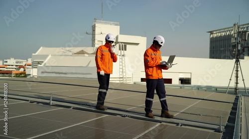 Wallpaper Mural Workers perform maintenance on solar panels at a rooftop installation site during the afternoon,   workers dressed in bright safety gear inspect and maintain solar panels on a rooftop. The clear sky Torontodigital.ca
