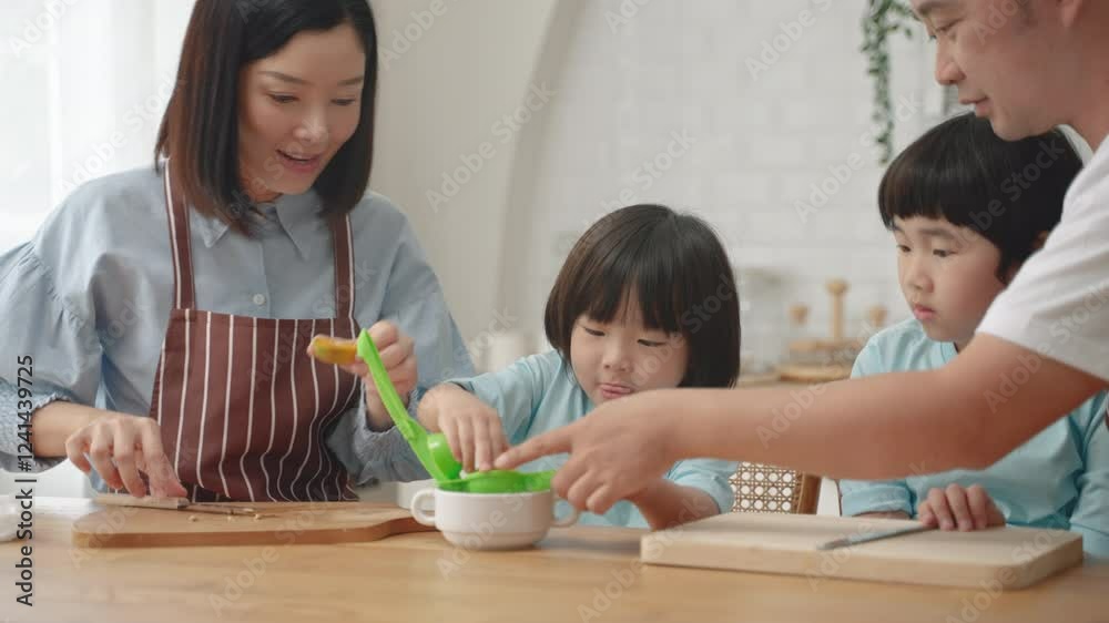 Asian family working together to squeeze orange juice
Asian family working together to squeeze orange juice