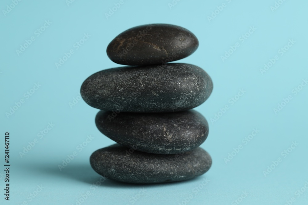 Stack of rocks on light blue background. Harmony and life balance Stack of rocks on light blue background. Harmony and life balance