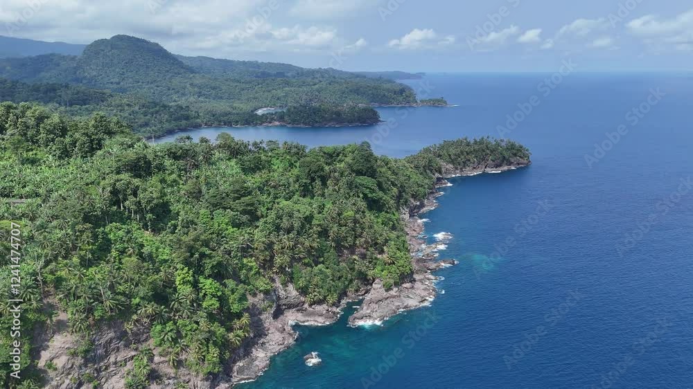 Sao Tome and Principe - Aerial View Near Micondo. Stunning Tropical Coastline With Lush Green Hills and Deep Blue Ocean. Sao Tome and Principe - Aerial View Near Micondo. Stunning Tropical Coastline With Lush Green Hills and Deep Blue Ocean.