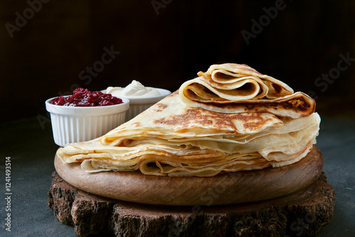 Delicious homemade pancakes with sour cream and jam photo