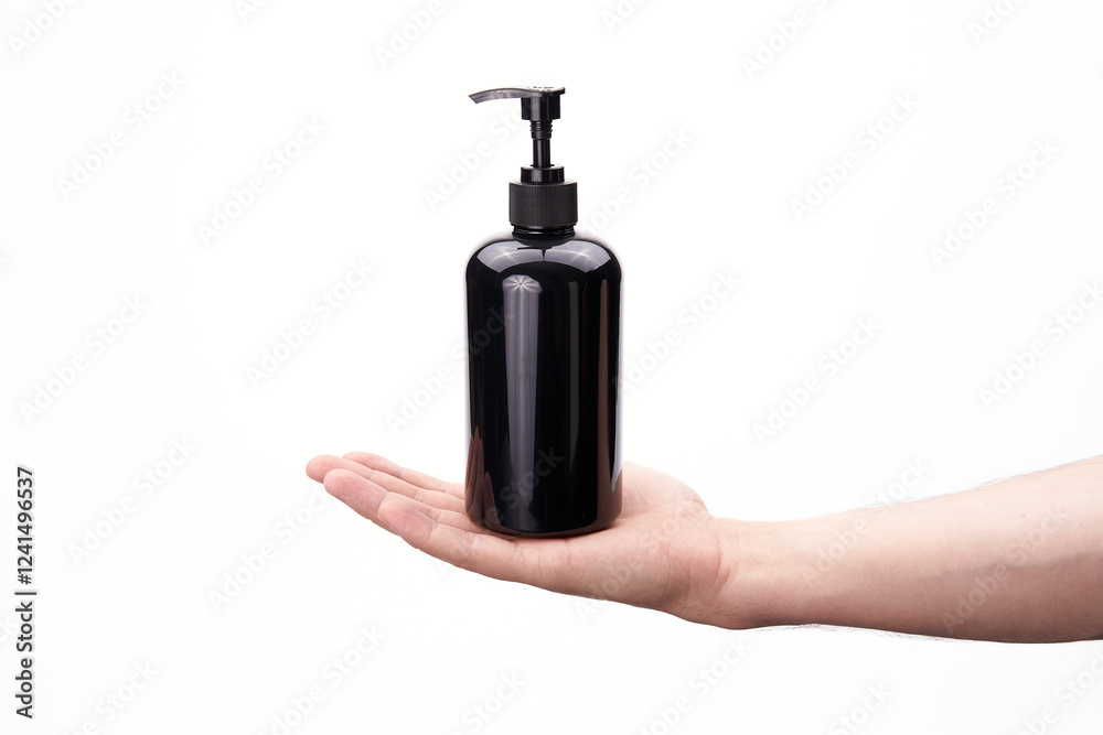 Black plastic dispenser in hand on a white background Black plastic dispenser in hand on a white background