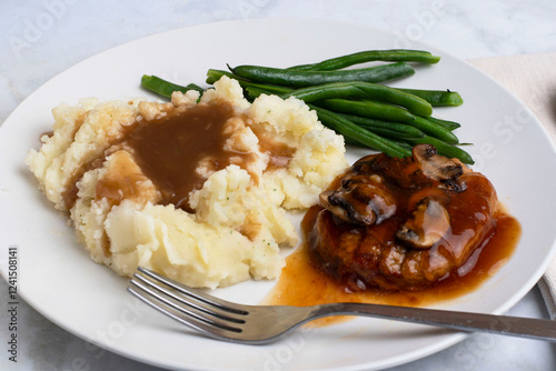 salisbury steak top with gravy, onions andmushrooms