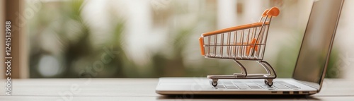 A miniature shopping cart sits on a laptop, symbolizing online shopping and e-commerce in a modern digital environment.