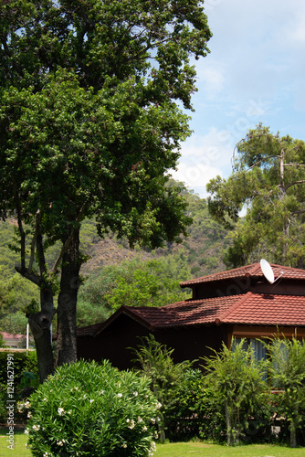 A red-roofed building surrounded by greenery.