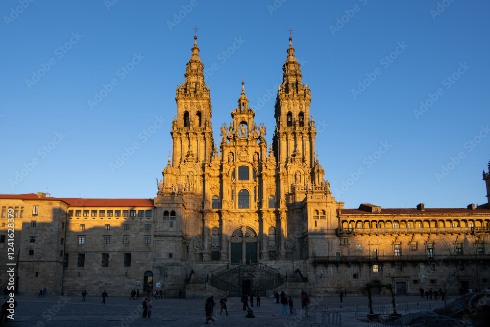 Fototapeta premium The Cathedral of Santiago de Compostela in Galicia, Spain, at sunset. Golden light bathes the Baroque facade and twin towers