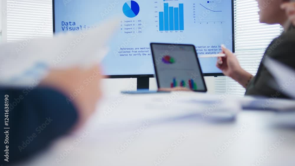 Group of Diverse business people collaboration with team meeting explaining strategy with graphs, charts analyze and discuss a financial data and information on TV monitor in meeting room at office.