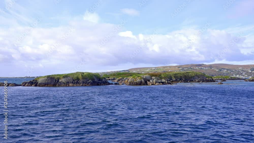 The Irish West Coast in Donegal Ireland - A picturesque and serene coastal view showcasing a rugged rocky shoreline alongside vibrant, colorful vegetation The Irish West Coast in Donegal Ireland - A picturesque and serene coastal view showcasing a rugged rocky shoreline alongside vibrant, colorful vegetation