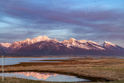 Photography Mission Mountains reflect into ponds at Ninepipe National Wildlife Refuge in the Mission Valley, Montana, USA