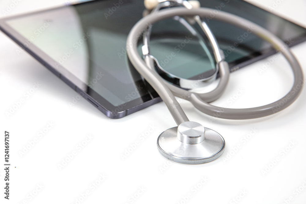 Telemedicine, medical stethoscope and digital tablet on white, closeup Telemedicine, medical stethoscope and digital tablet on white, closeup