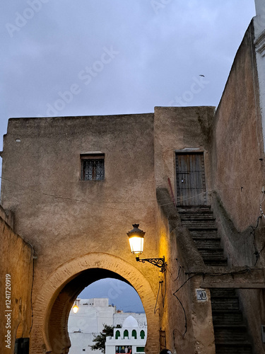 Stunning Twilight View of an Ancient Archway and Stairway in a Historic Town, Surrounded by Soft Evening Light
