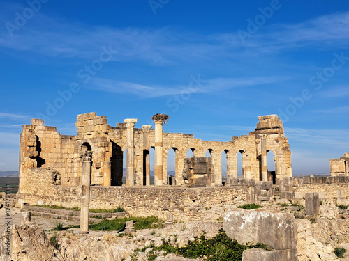 Exploring Ancient Ruins Under a Clear Blue Sky in a Historic Landscape