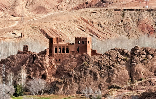 Ruins of an Ancient Fortress Stand Majestically Against a Backdrop of Arid Mountains in Late Afternoon Light