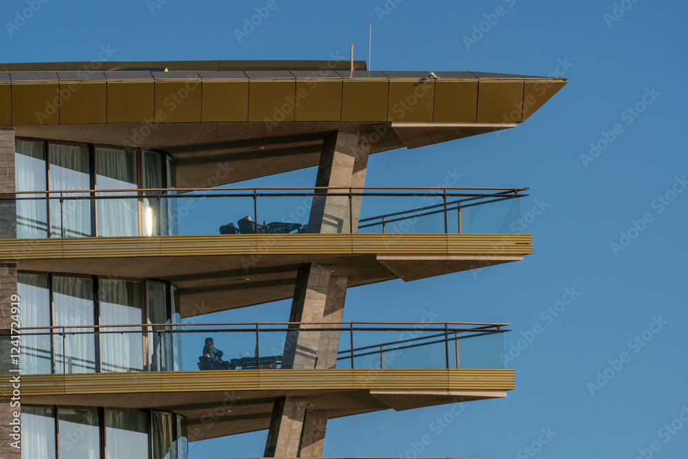 Balcony Building Modern Architecture - A close-up shot of a modern building with three balconies and a blue sky in the background. Balcony Building Modern Architecture - A close-up shot of a modern building with three balconies and a blue sky in the background.