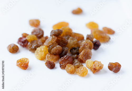 A bunch of tasty and appetizing raisins of yellow and brown color, on a light background. Natural and healthy sweets