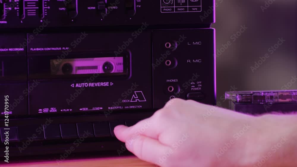 Retro radio tape recorder, audio cassette close-up. Listening to music, old radio boom box player, macro of vintage music listening. 