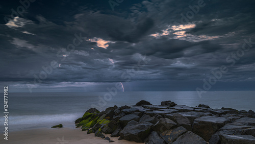 USA, New Jersey, Cape May National Seashore. Sunrise on shoreline storm cloud...