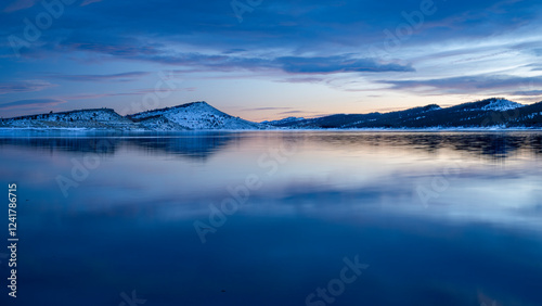 winter dusk over calm Carter Lake in northern Colorado at foothills of Rocky Mountains